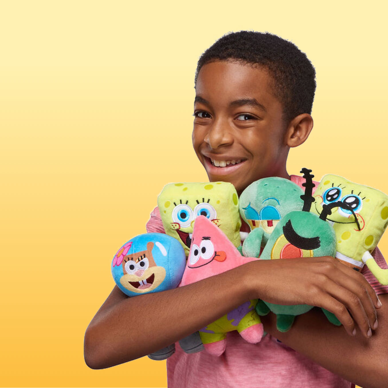 boy holding collection of spongebob squarepants character plush toys